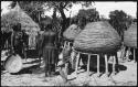 Women standing next to storage baskets