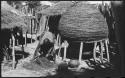 Woman working and leaning over, with storage basket behind her