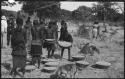 Women putting baskets of grain down