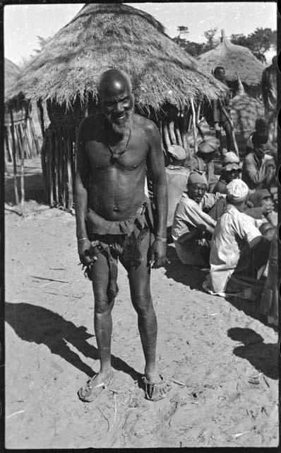 Man standing next to a group of people sitting