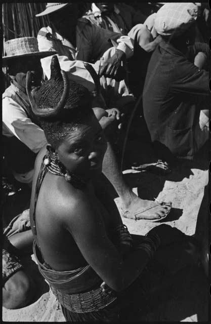 Woman sitting with a group, close-up