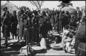 Women standing near sacks and baskets of grain