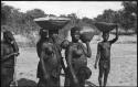 Women carrying baskets on their heads and babies on their backs