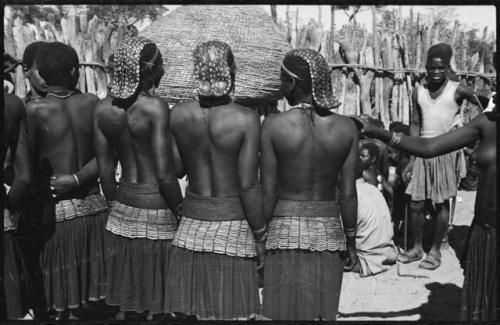 Women standing in front of storage basket, with their backs to the camera