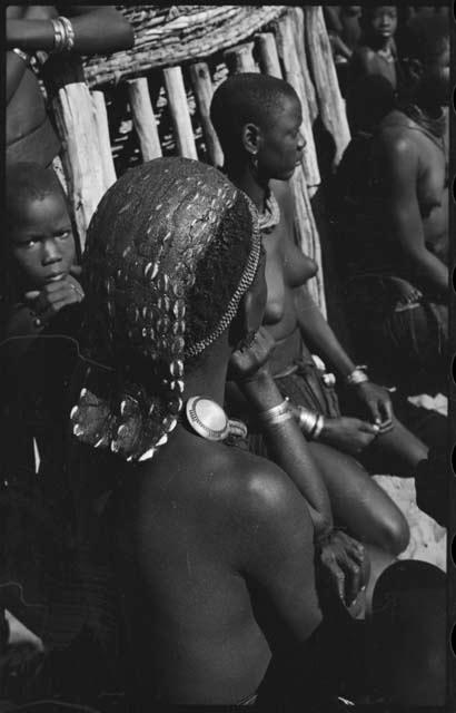 Woman sitting with a group, close-up showing her hairstyle