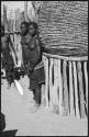 Women standing next to storage basket