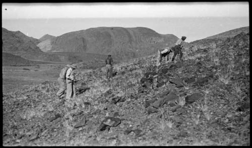 Five men climbing a hill, looking for tin ore