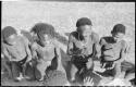 Group of men and boys kneeling