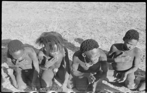 Group of men and boys kneeling