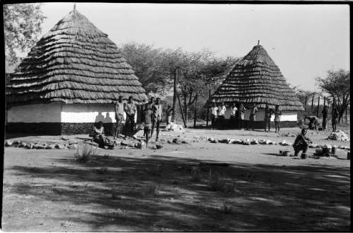 People standing and sitting in front of buildings