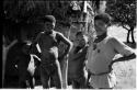 Boys standing beside the Okwa hut with wall drawings