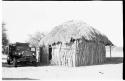 Okwa hut with a vehicle beside it