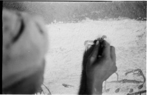 Boy drawing on the wall in Okwa