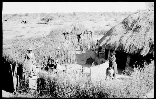 Boys and his family standing in the kraal (clearing) of his home