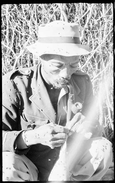 Boys smoking a pipe and sewing