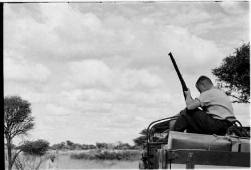 Theunis Berger on top of the truck holding a gun