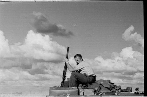 Theunis Berger on top of the truck holding a gun