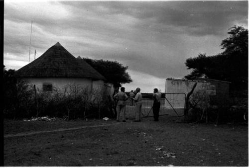 Laurence Marshall, John Marshall, and L. F. Maingard at gate of administration compound at Tsani