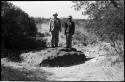 Two men standing on the Hoba meteorite