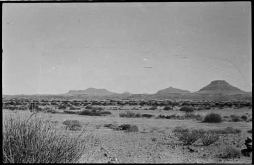 Small pile of rocks at right, with hills in the distance