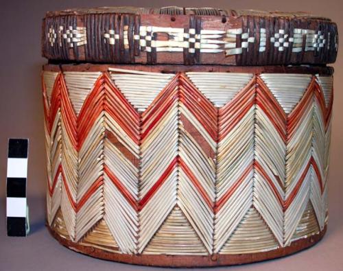 Small wooden box covered with embroidered grass pieces.