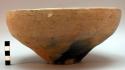 Taper sided bowl, tayou; sporadic black coloration on tan bowl