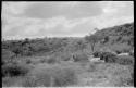 Three huts in a riverbed