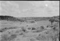 Three huts near a field