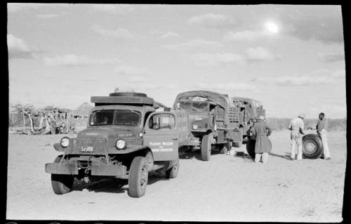 Expedition members changing the tire of the GMC truck