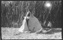 Elderly woman sitting wrapped in a kaross