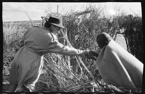 Elderly person receiving tobacco from Lorna Marshall