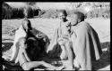 Group of five people, one smoking a cigarette