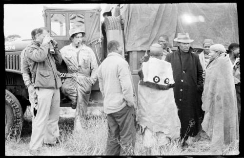 Wilhelm Camm talking to a group of men beside the truck