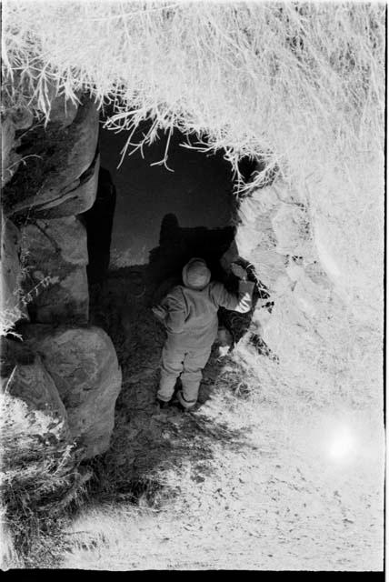 Robert Story drinking from a waterhole