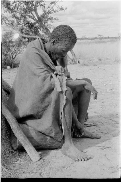 Headman at Kungwane sitting looking at the ground