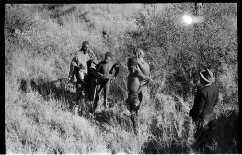 Elderly blind man led by a boy using a long stick