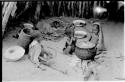 Three seated children beside a cooking pot at Chukudu