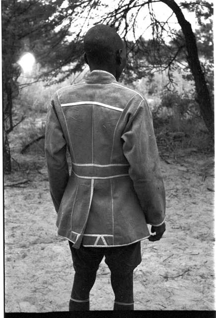 Boy in a tailored leather coat, back view