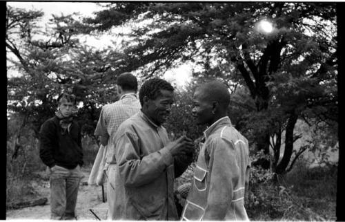 /Gishay talking to the boy in the tailored coat; John Marshall and William Donnellan in the background