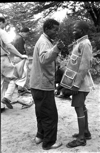 /Gishay talking to boat in the tailored leather coat; John Marshall and Bill Donnellan in the background