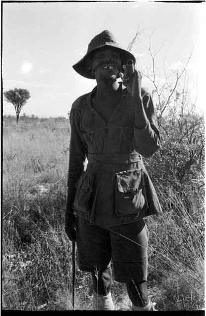 Headman carrying a gun over his shoulder