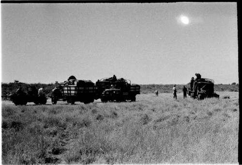 Expedition members and trucks at !Kusi Pan, from a distance