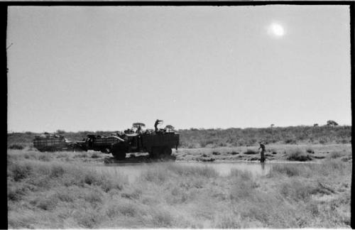 Expedition members and trucks at !Kusi Pan, from a distance