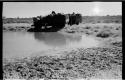 Expedition members and trucks at !Kusi Pan, from a distance