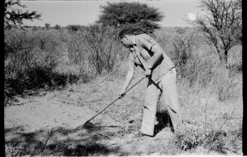 Bill Donnellan raking a place for tents