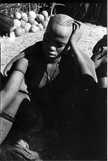 Woman with a striped haircut, sitting