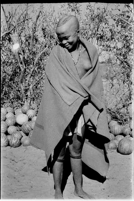 Woman with striped haircut wrapped in a blanket