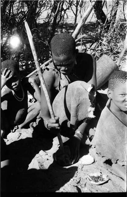 Woman with a digging stick in a tsama melon