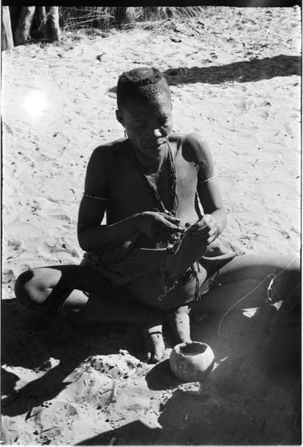 Woman sitting, sewing