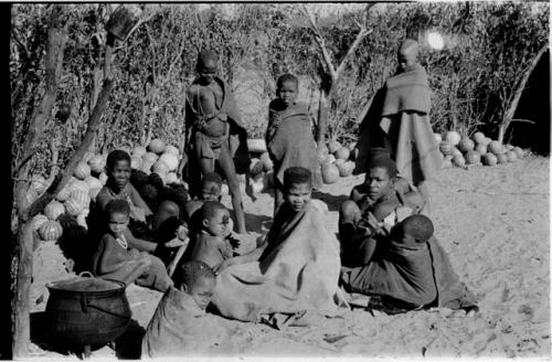 Group sitting by a pile of tsama melons